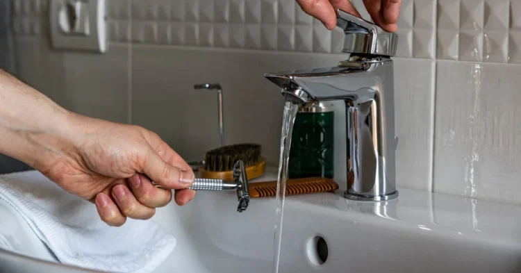 Person Holding Stainless Steel Faucet
