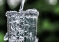 Air jernih dituangkan ke dalam gelas kaca, ilustrasi keutamaan air zamzam yang penuh berkah