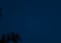 Bulan sabit bersinar di langit malam biru gelap, ilustrasi keutamaan bulan Muharram sebagai bulan Allah