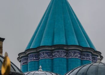 Kubah hijau toska bertuliskan kaligrafi Arab pada makam bersejarah, ilustrasi pembahasan hukum ziarah ke makam wali